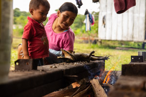 Obe cooks caiman with son